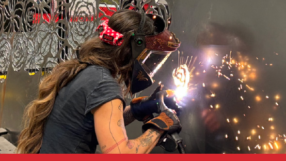 Image of Rae cutting metal